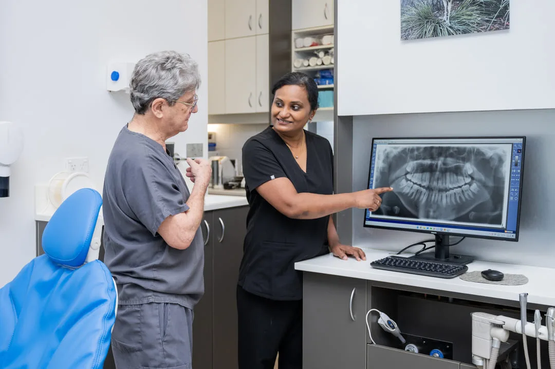 Dr Suganthy reviewing a full-mouth panoramic X-ray on screen at Beyond Smiles Family Dental